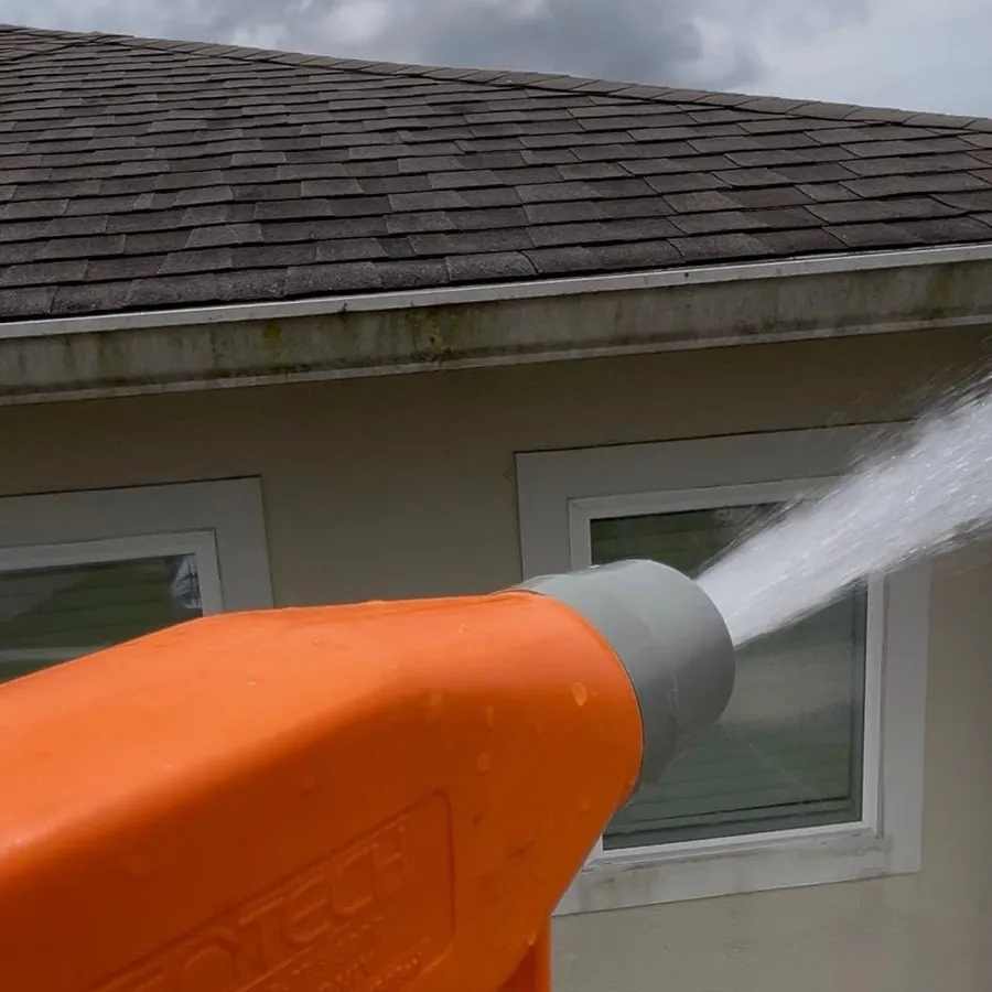 CF Surface Solutions soft wash gun rinsing a home exterior from the roof